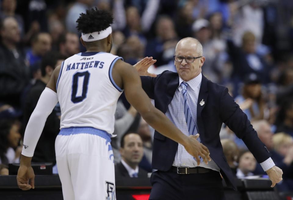 Rhode Island head coach Dan Hurley, right, celebrates a play with guard E.C. Matthews during the first half of an NCAA college basketball championship game against Davidson in the Atlantic 10 Conference tournament, Sunday, March 11, 2018, in Washington. (AP Photo/Alex Brandon) ORG XMIT: VZN109