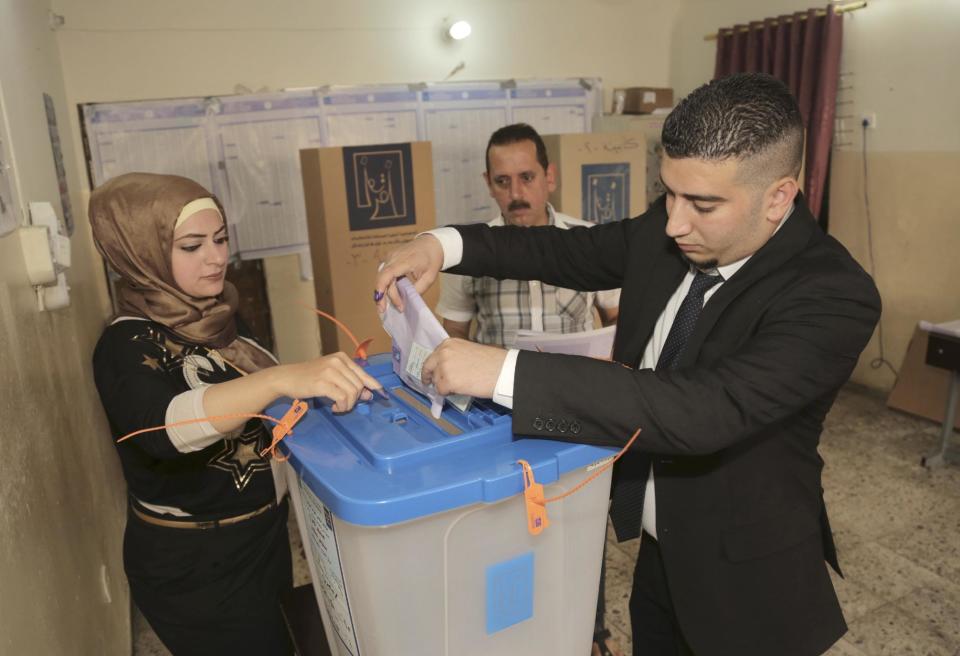 An Iraqi man casts his vote at a polling station in Baghdad, Iraq, Wednesday, April 30, 2014. A key election for a new Iraqi parliament was underway on Wednesday amid a massive security operation as the country continued to slide deeper into sectarian violence more than two years after U.S. forces left the country. (AP Photo/Khalid Mohammed)