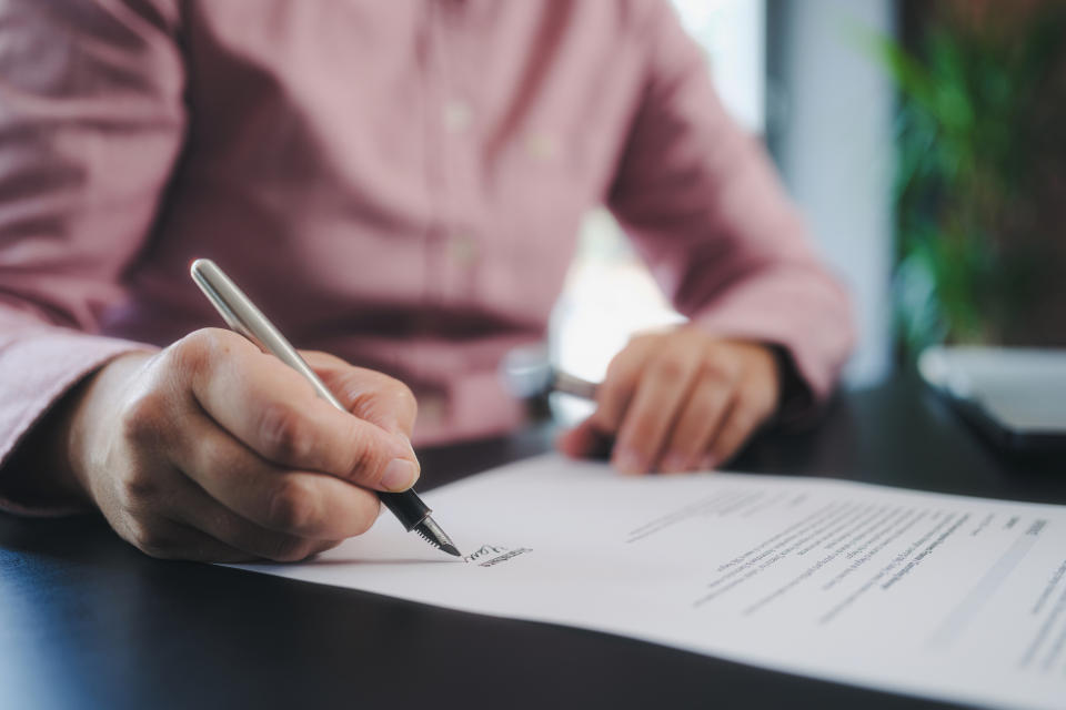 A person signing papers