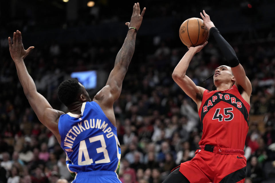 Toronto Raptors guard Dalano Banton (45) shoots over Milwaukee Bucks forward Thanasis Antetokounmpo (43) during second half of an NBA basketball action in Toronto, Sunday, April 9, 2023. (Frank Gunn/The Canadian Press via AP)