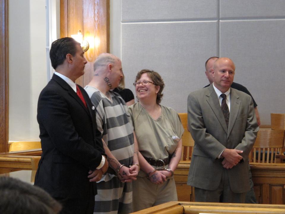 Jeremy Moody, left, talks to his wife, Christine Moody, right, while standing with their lawyers shortly before they were both sentenced to life in prison on Tuesday, May 6, 2014, in Union, S.C. Prosecutors said the couple killed Charles Parker in his home in July 2013 because he was a sex offender and his wife Gretchen Parker because she was there. (AP Photo/Jeffrey Collins)