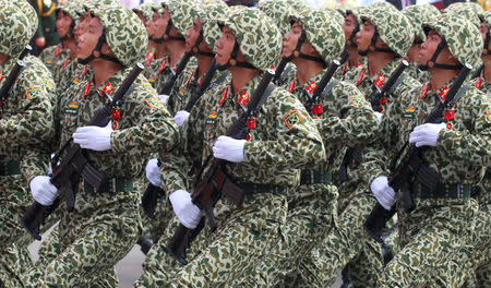 Soldiers hold rifles while marching during a celebration to mark Reunification Day in Ho Chi Minh city, Vietnam April 30, 2015. REUTERS/Kham