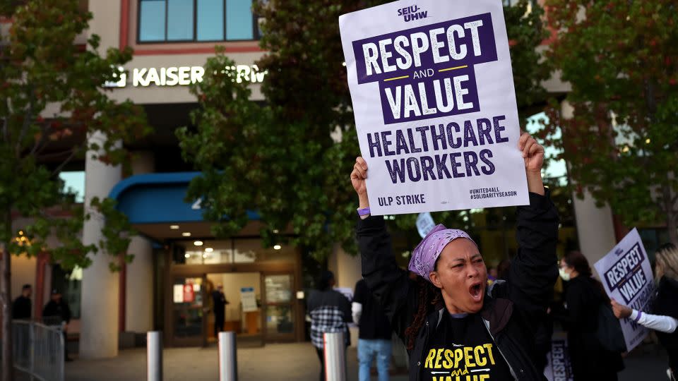 Striking Kaiser Permanente workers hold signs as they march in front of the Kaiser Permanente San Francisco Medical Center on October 04, 2023 in San Francisco, California. More than 75,000 Kaiser Permanente workers went on strike Wednesday morning at hospitals and medical facilities in five states after labor negotiators could not reach an agreement to resolve a staffing level dispute.  - Justin Sullivan/Getty Images