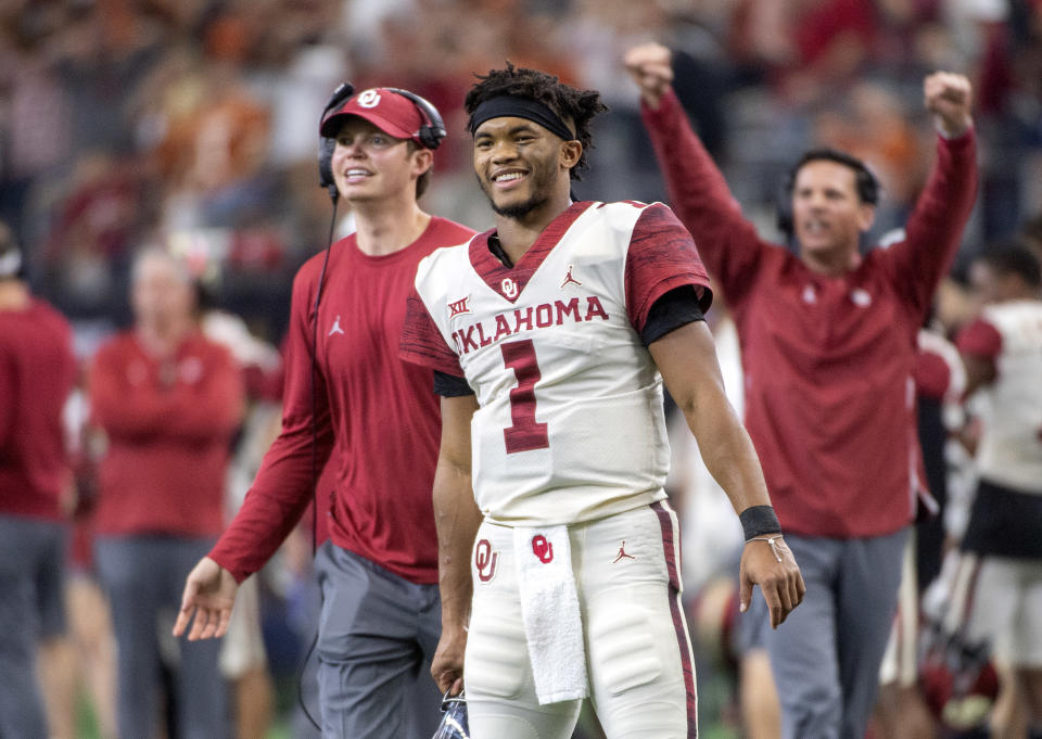 FILE - In this Dec. 1, 2018, file photo, Oklahoma quarterback Kyler Murray (1) celebrates on the sidelines after throwing a touchdown against Oklahoma during the second half of the Big 12 Conference championship NCAA college football game, in Arlington, Texas. Murray was named The Associated Press college football Player of the Year, Thursday, Dec. 6, 2018. (AP Photo/Jeffrey McWhorter, File)
