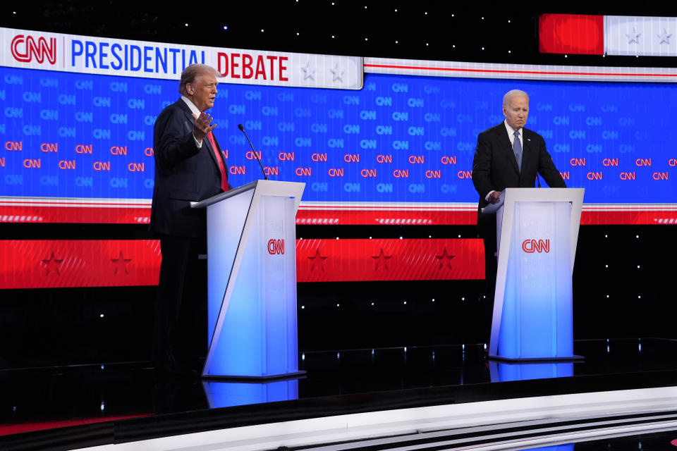 President Joe Biden, right, listens as Republican presidential candidate former President Donald Trump speaks during a presidential debate hosted by CNN, Thursday, June 27, 2024, in Atlanta. (AP Photo/Gerald Herbert)