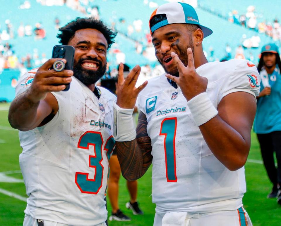 Miami Dolphins running back Raheem Mostert (31) and quarterback Tua Tagovailoa (1) celebrate on the field after defeating the Carolina Panthers at Hard Rock Stadium in Miami Gardens on Sunday, October 15, 2023.