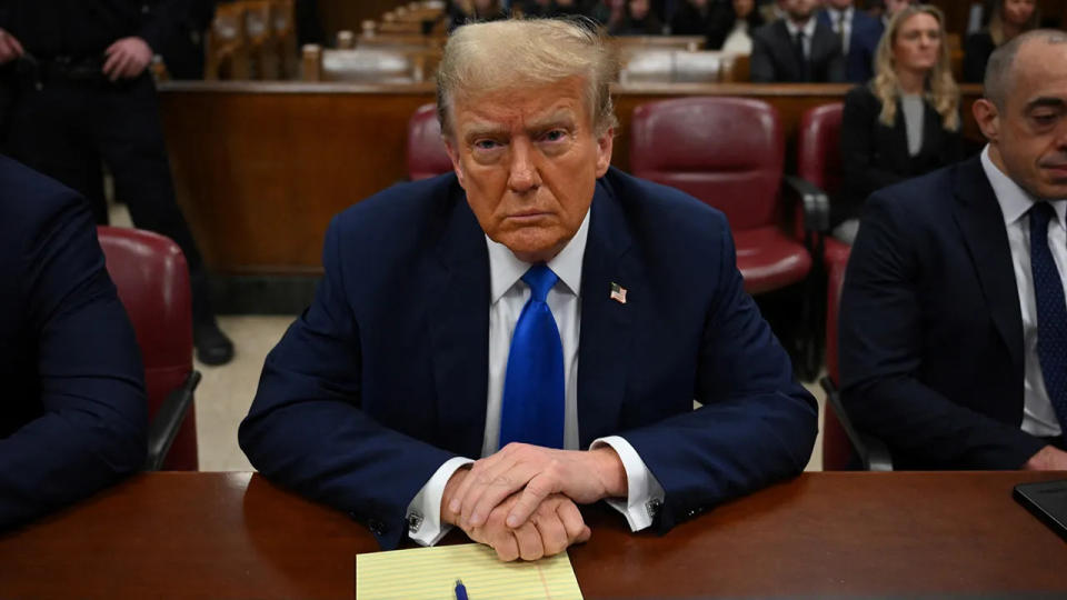 Donald Trump sits in the courtroom for the first day of opening arguments in his Manhattan criminal trial.