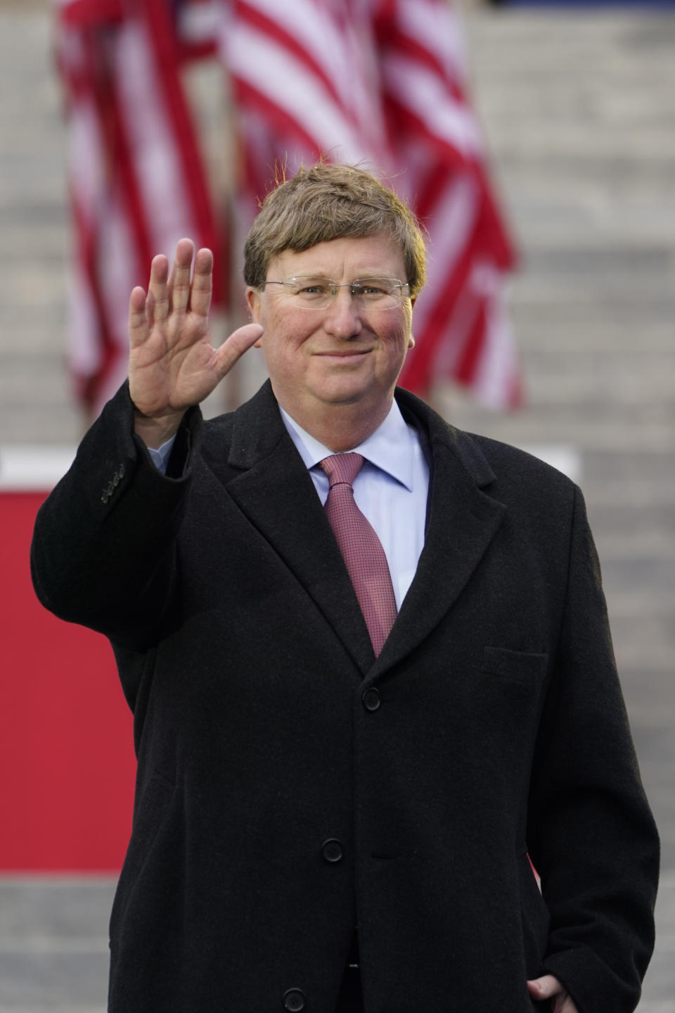 Mississippi Republican Gov. Tate Reeves waves prior to delivering his address during his inauguration for a second term as head of state, at the Mississippi State Capitol in Jackson, Miss., Tuesday, Jan. 9, 2024. (AP Photo/Rogelio V. Solis)