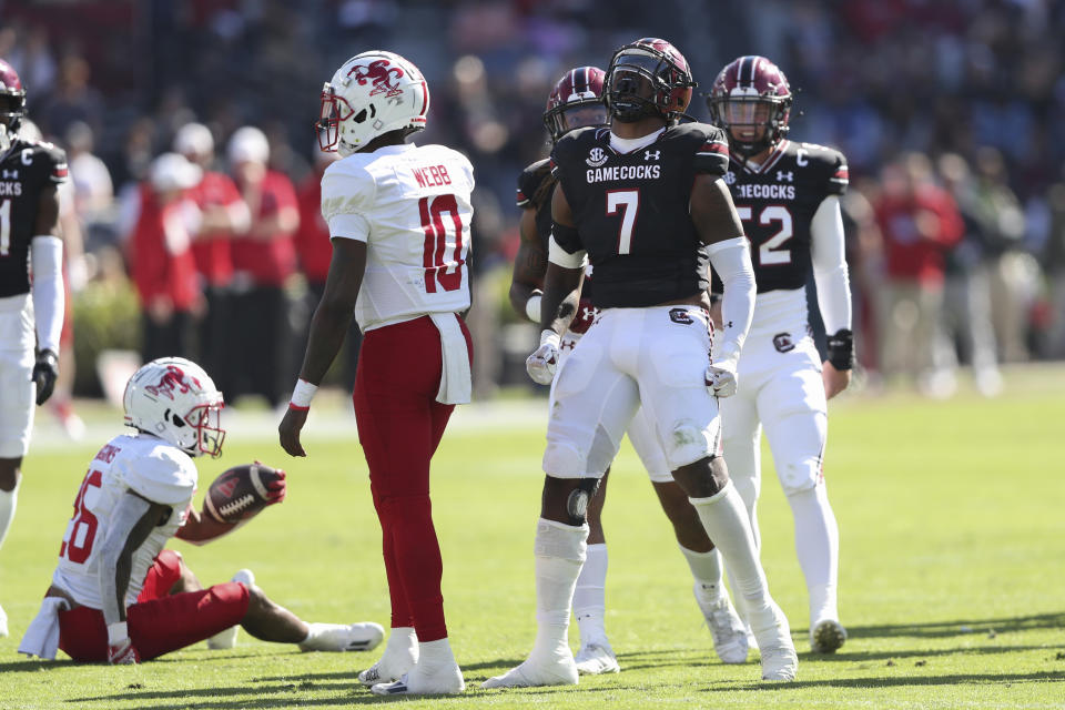 South Carolina defensive end Jordan Strachan (7) celebrates after tackling Jacksonville State running back Ron Wiggins (26) for a loss during the first half of an NCAA college football game on Saturday, Nov. 4, 2023, in Columbia, S.C. (AP Photo/Artie Walker Jr.)