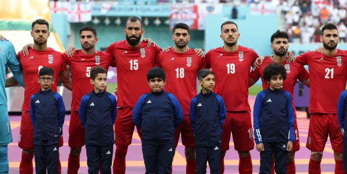 Iran players listen to the national anthem ahead of the Qatar 2022 World Cup Group B football match between England and Iran at the Khalifa International Stadium in Doha on November 21, 2022.