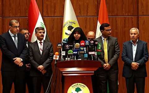 Najiha Abdul-Amir al-Shimari, center, the head of Iraq's Martyrs Establishment speaks during a press conference, in Baghdad, Iraq, Tuesday, March 20, 2018 - Credit: AP