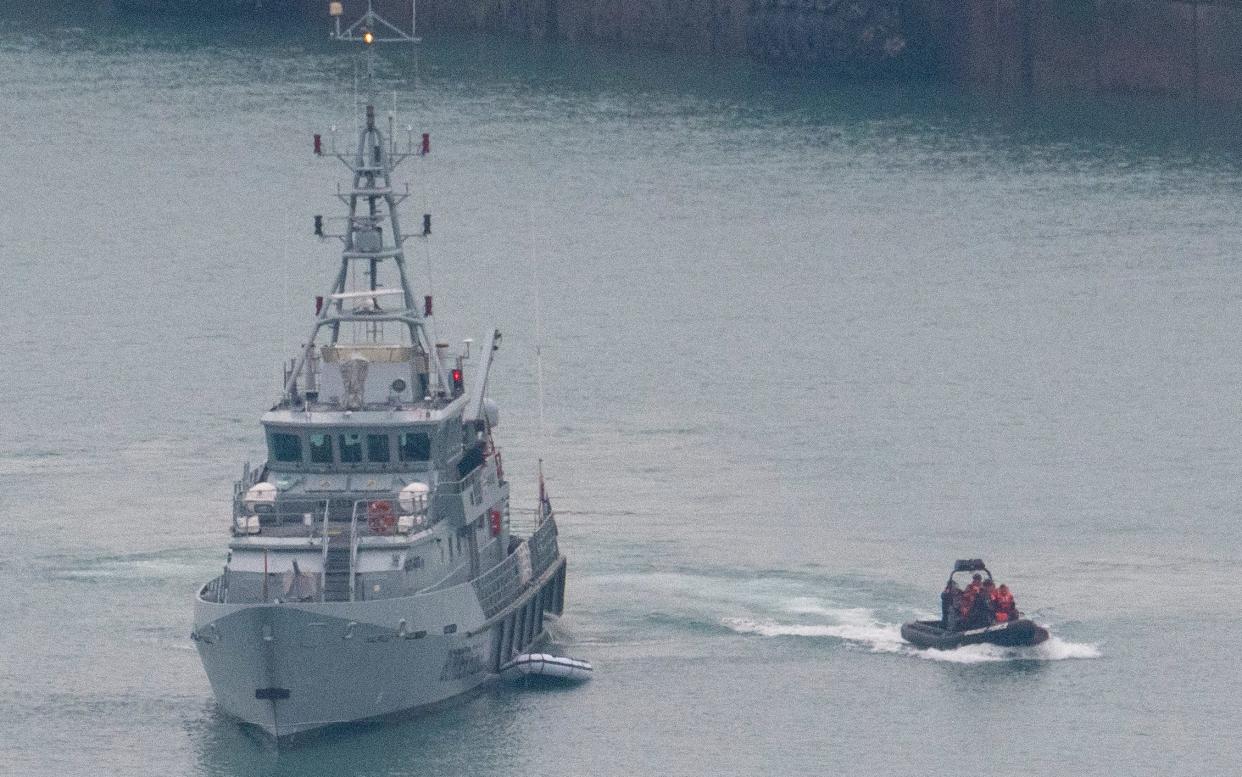 Border Force and Port Authority workers bring a boat carrying suspected migrants ashore - Steve Finn