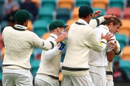 Joe Mennie celebrates with teammates after dismissing South Africa's Temba Bavuma. Australia v South Africa - Second Test cricket match - Bellerive Oval, Hobart, Australia - 14/11/16 Australia's. REUTERS/David Gray