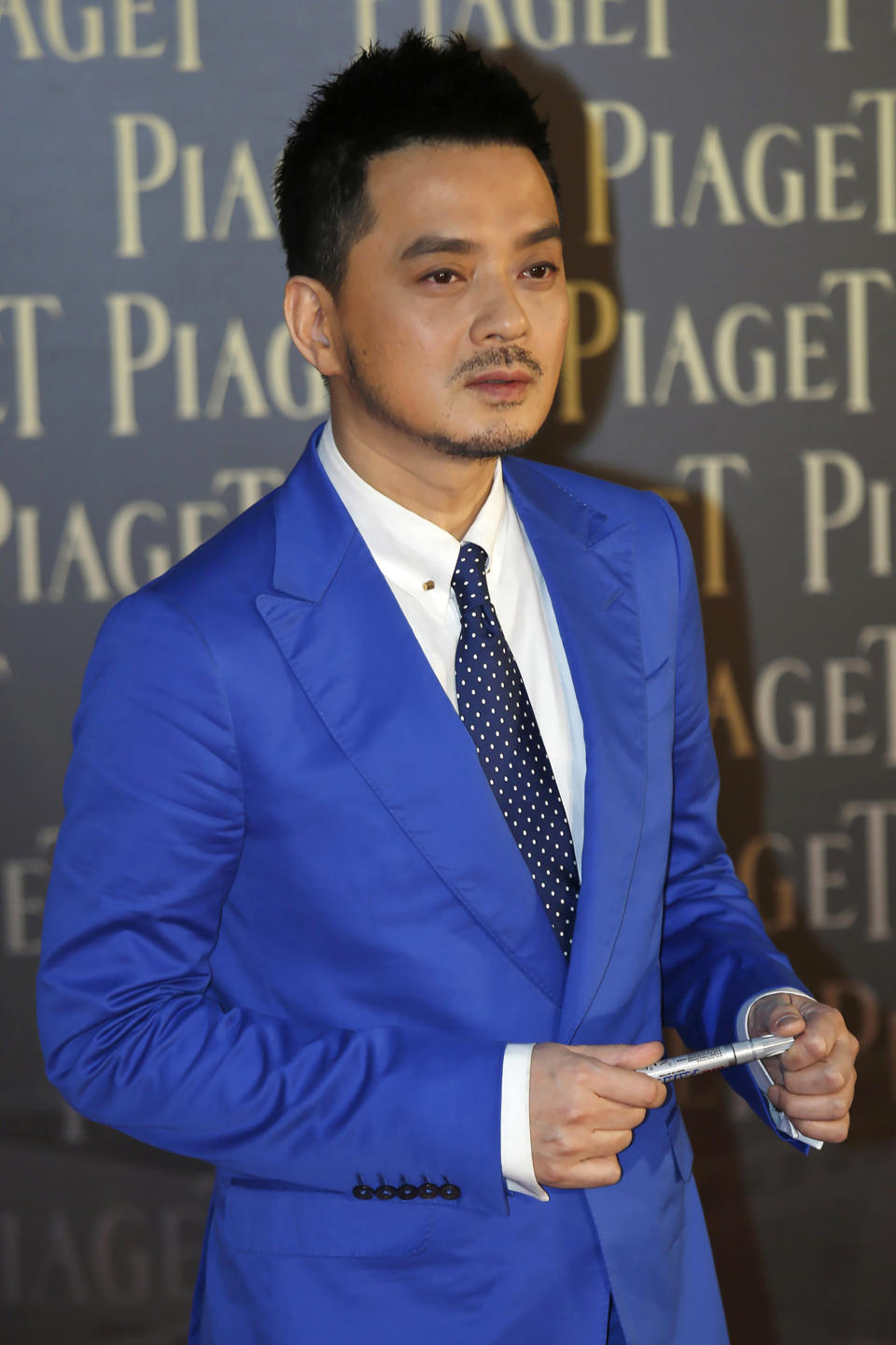 In this Saturday, April 13, 2013, file photo, Hong Kong singer Anthony Wong Yiu-ming poses for photographers on the red carpet of the 32nd Hong Kong Film Awards in Hong Kong. Wong was arrested Monday, Aug. 2, 2021, by the city's anti-corruption watchdog, over accusations of corrupt conduct during a 2018 election, the latest move by authorities amid a crackdown on political dissent in the city. (AP Photo/Vincent Yu, File)