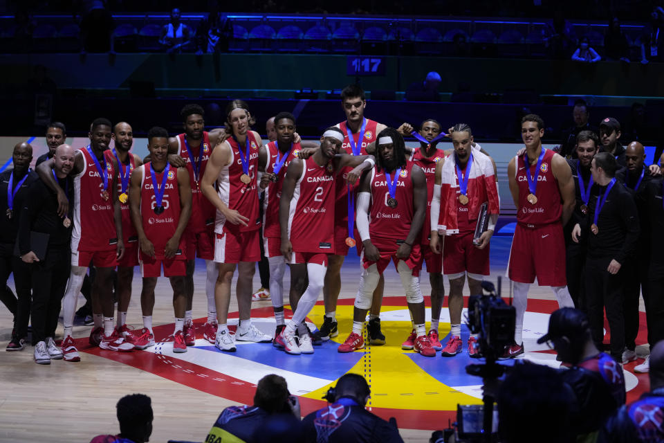 Canada players pose for a photo after the Basketball World Cup bronze medal game between the United States and Canada in Manila, Philippines, Sunday, Sept. 10, 2023. (AP Photo/Michael Conroy)