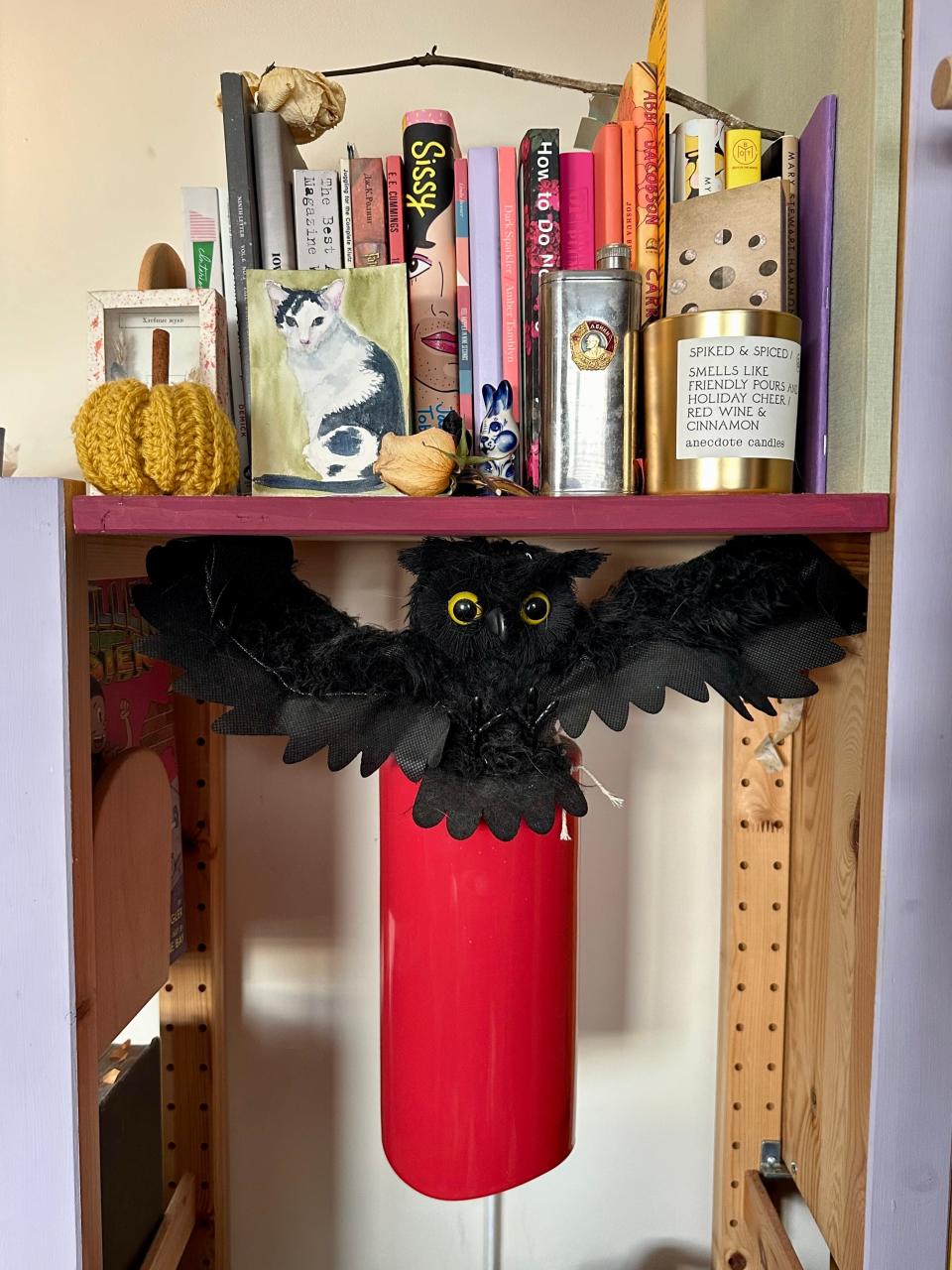 Halloween decorations including a black winged creature and a crocheted pumpkin