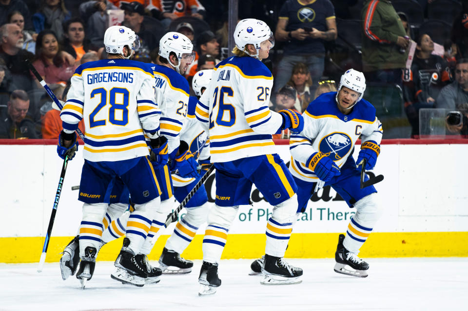 Buffalo Sabres' Kyle Okposo, right, celebrates his goal against the Philadelphia Flyers with teammates during the first period of an NHL hockey game Saturday, April 1, 2023, in Philadelphia. (AP Photo/Chris Szagola)