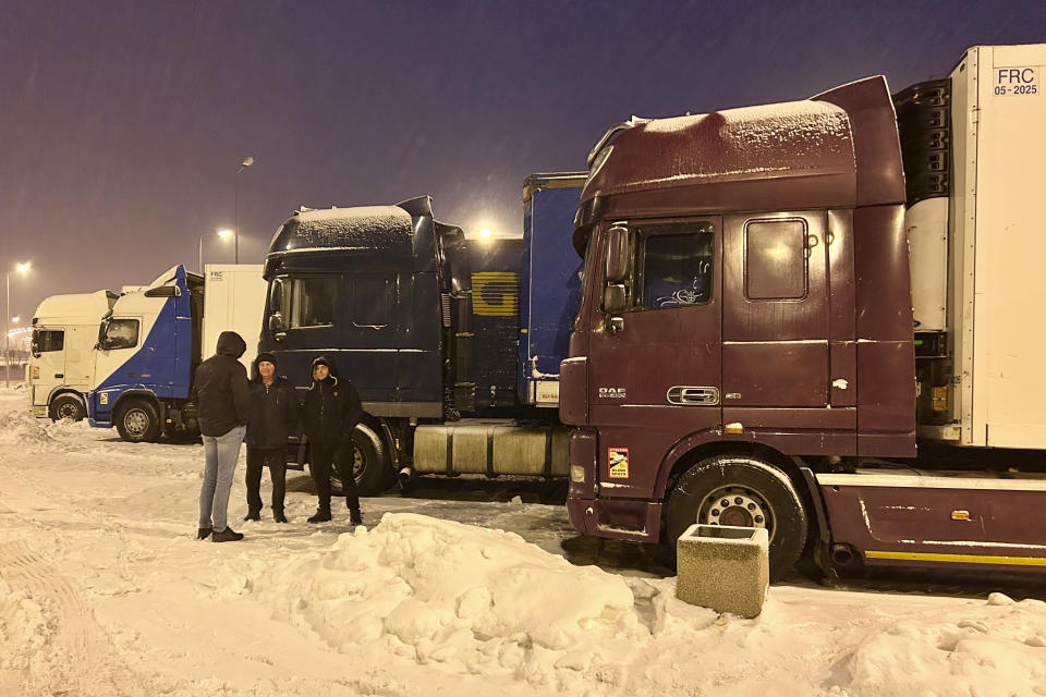 Ukrainian truck drivers wait to cross from Poland back into Ukraine in Korczowa, Poland, on Thursday Dec. 7, 2023. Ukrainian charities and companies supplying the country’s military warn that problems are growing as Polish truck drivers show no sign of ending a monthlong border blockade. (AP Photo/Karl Ritter)