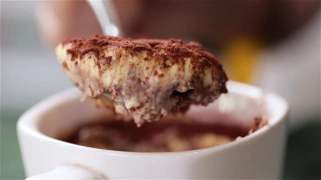 Scooping Tiramisu with a spoon