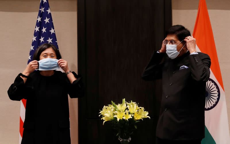 U.S. Trade Representative Katherine Tai and India's Minister of Commerce and Industry, Piyush Goyal, adjust their face masks before start of their meeting in New Delhi