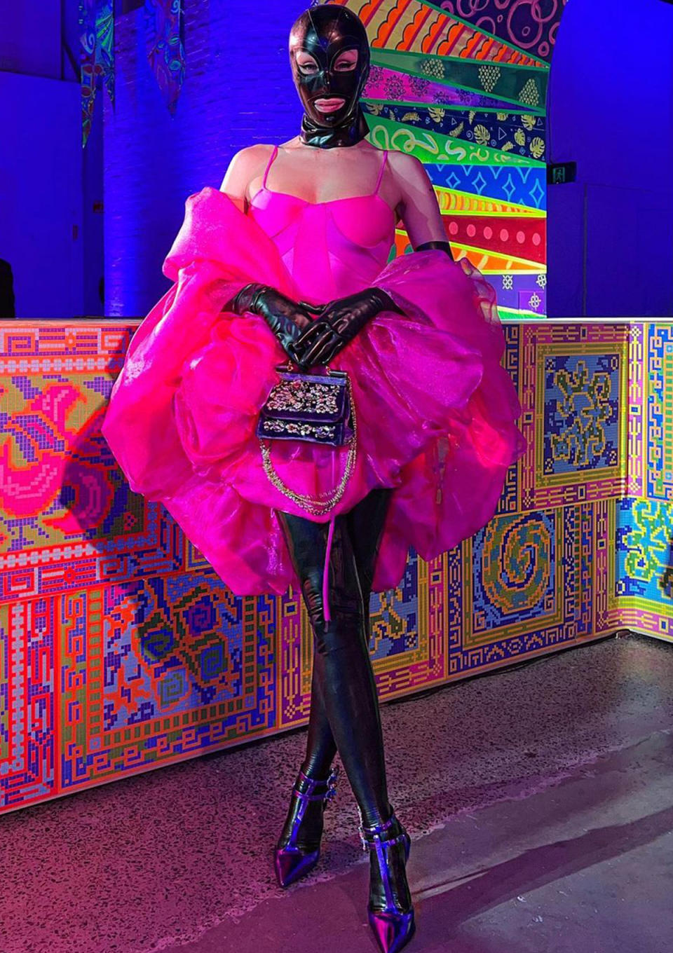 Imogen Anthony at Australian Fashion week wearing a black gimp mask and hot pink outfit. 