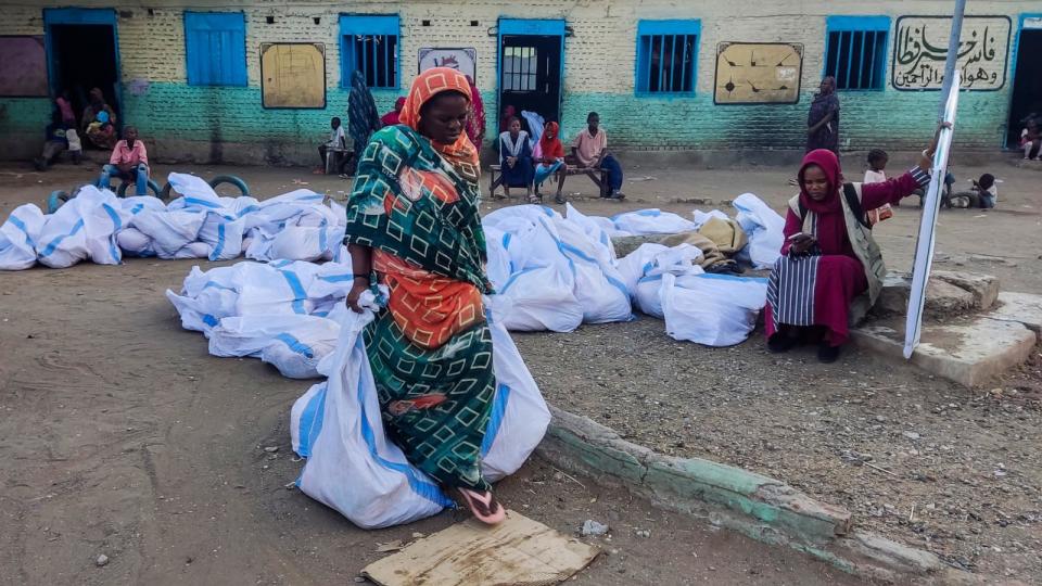 PHOTO: An internally displaced woman carries aids in sacks after collecting from a group at a camp in Gedaref, Sudan, on May 12, 2024.  (AFP via Getty Images)