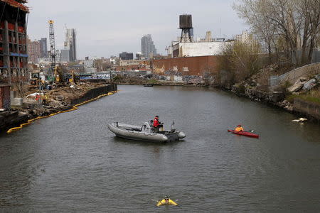 Christopher Swain, a clean-water activist, swims in the Gowanus Canal in the Brooklyn borough of New York April 22, 2015. REUTERS/Shannon Stapleton