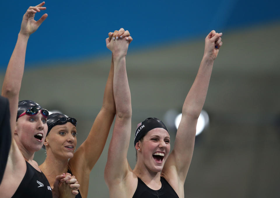 LONDON, ENGLAND - AUGUST 01: Shannon Vreeland, Dana Vollmer and Missy Franklin of the United States celebrate after they won the Final of the Women's 4x200m Freestyle Relay on Day 5 of the London 2012 Olympic Games at the Aquatics Centre on August 1, 2012 in London, England. (Photo by Clive Rose/Getty Images)