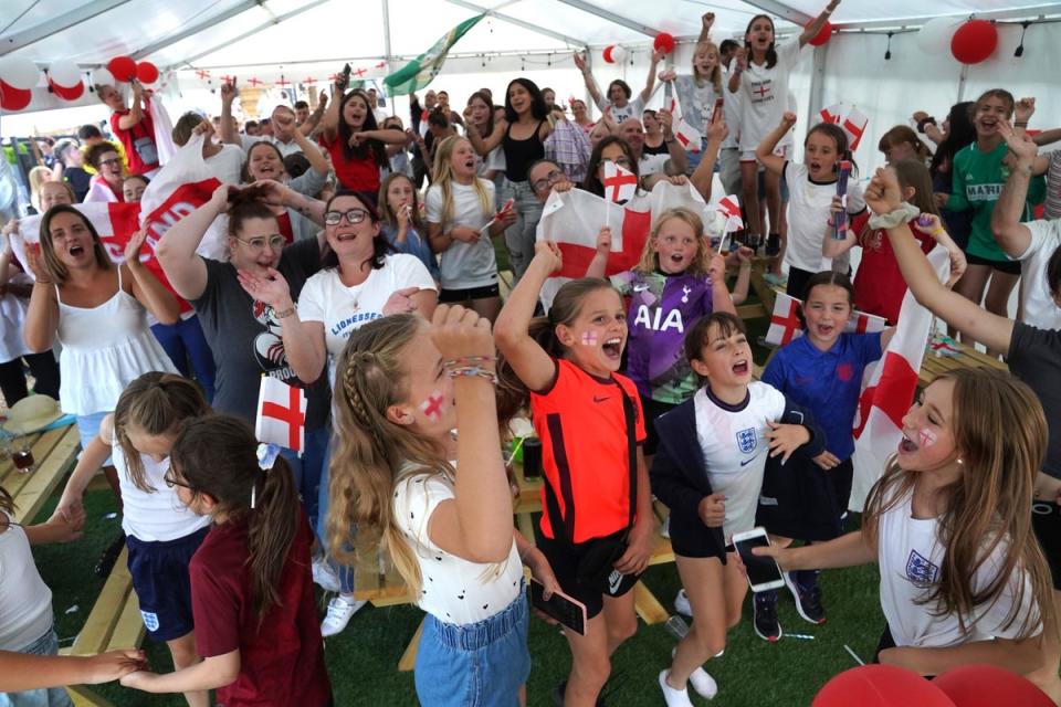 Fans celebrate in Aylesbury United WFC, the former club of Lioness Ellen White (PA)