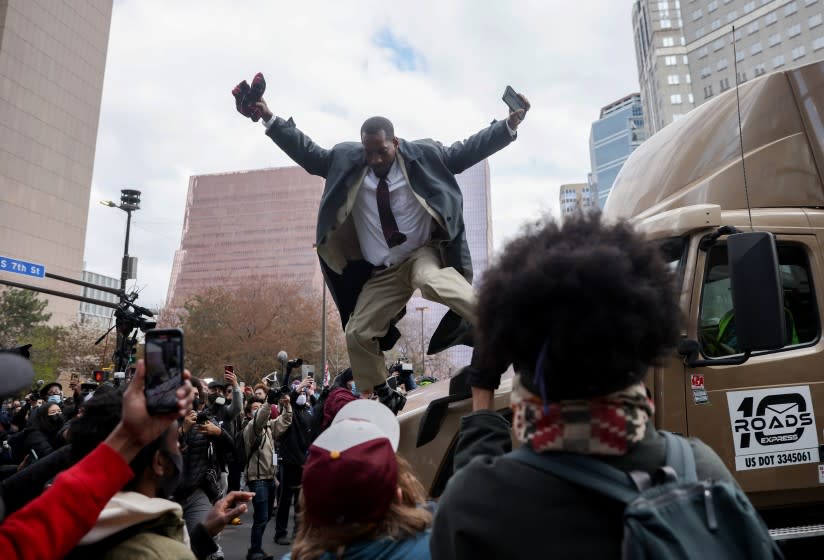 MINNEAPOLIS, MINNESOTA - APRIL 20: A man jumps down from a truck which had attempted to make its way past the crowd as people react after the verdict was read in the Derek Chauvin trial on April 20, 2021 In Minneapolis, Minnesota. Former police officer Derek Chauvin was on trial on second-degree murder, third-degree murder and second-degree manslaughter charges in the death of George Floyd May 25, 2020. After video was released of then-officer Chauvin kneeling on Floyd's neck for nine minutes and twenty-nine seconds, protests broke out across the U.S. and around the world. The jury found Chauvin guilty on all three charges. (Photo by Scott Olson/Getty Images)