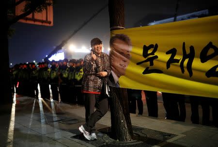 A supporter of South Korea's president-elect Moon Jae-in gives a thumbs-up at Gwanghwamun Square in Seoul, South Korea, May 10, 2017. REUTERS/Kim Hong-Ji