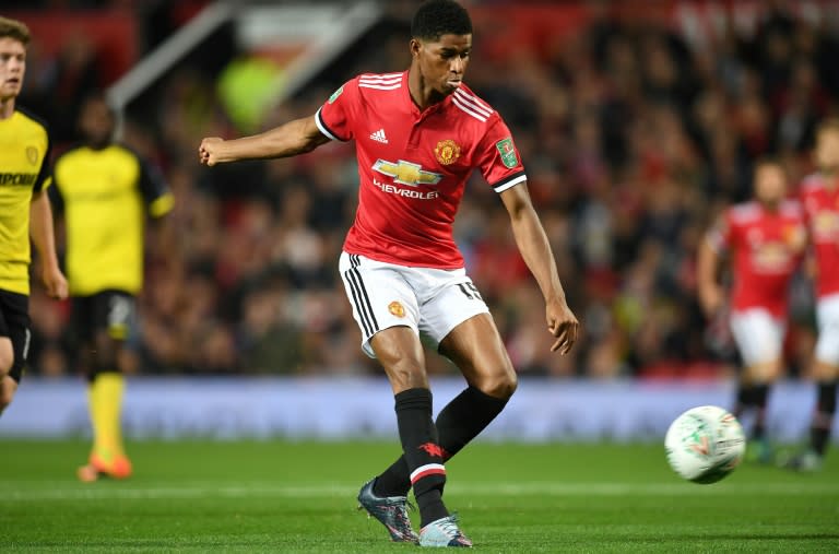 Manchester United's Marcus Rashford scores the opening goal during their match against Burton Albion at Old Trafford in Manchester on September 20, 2017