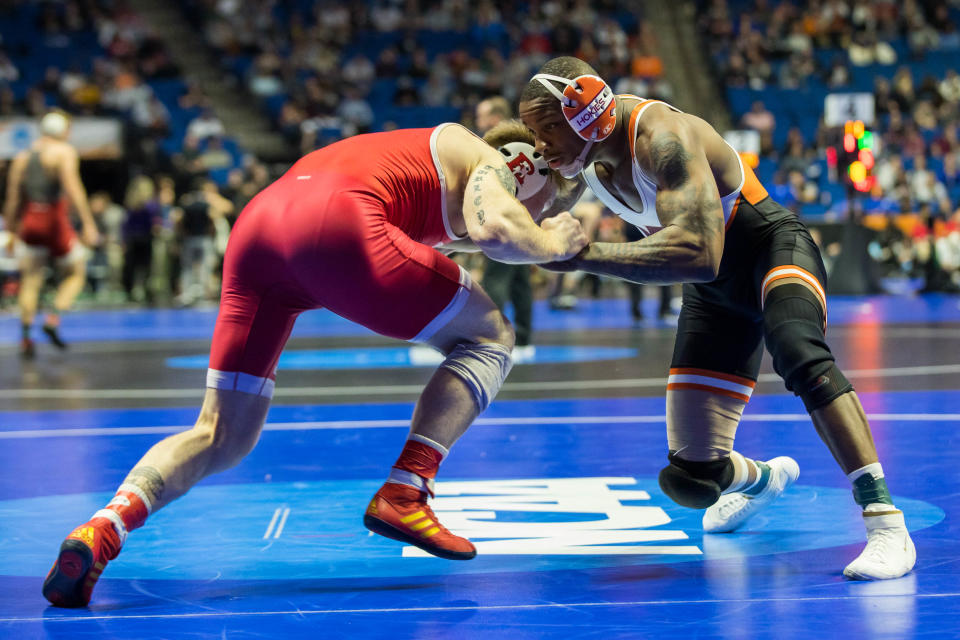 Virginia Tech's Mekhi Lewis (right), shown wrestling Rutgers' Jackson Turley in a first-round bout, advanced to the 174-pound quarterfinals in the NCAA Tournament Thursday night.