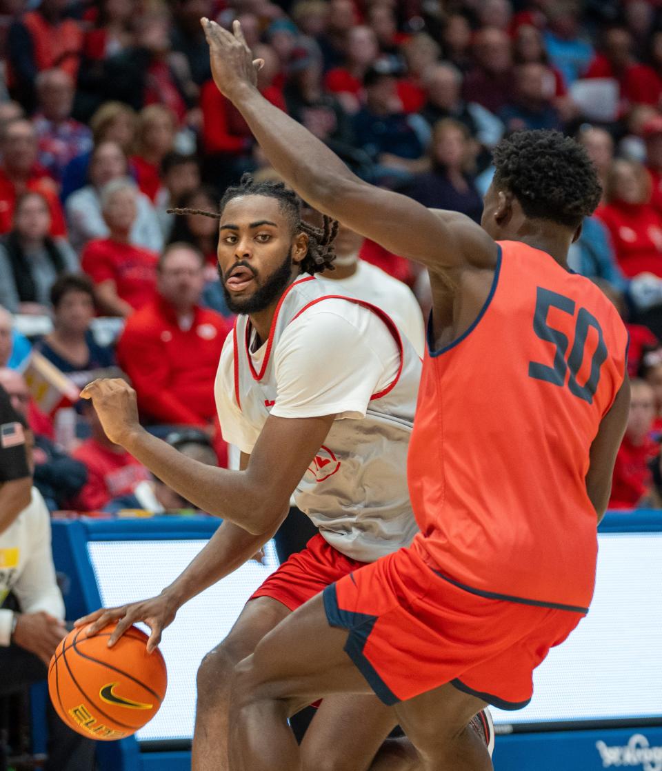 Oct 22, 2023; Dayton, OH, USA;
Ohio State Buckeyes guard Evan Mahaffey (12) attempts to make his way to the basket past Dayton Flyers guard Enoch Cheeks (50) during their game on Sunday, Oct. 22, 2023 at University of Dayton Arena.