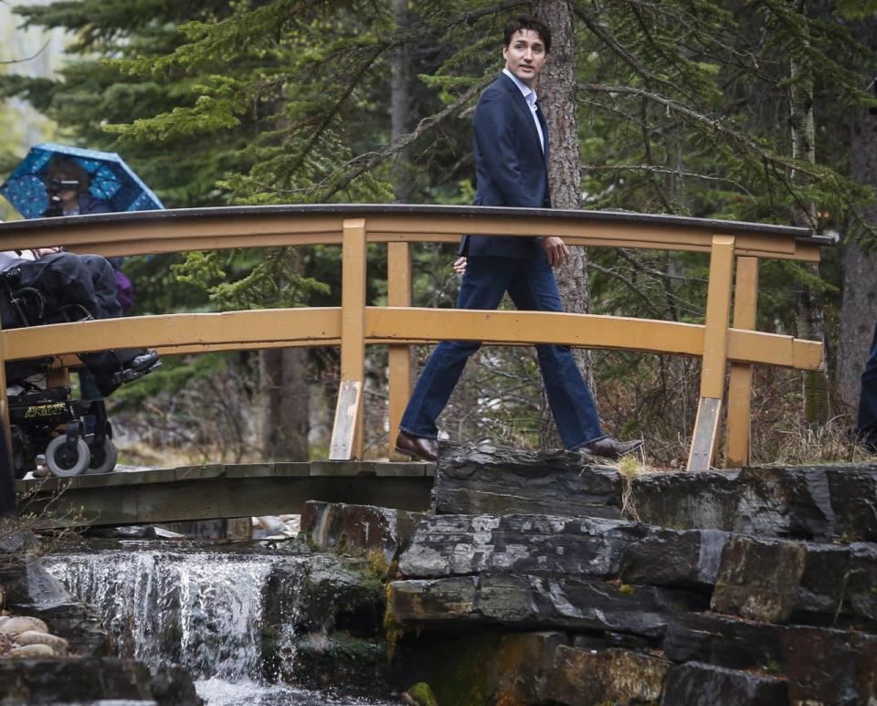 Prime Minister Justin Trudeau, centre, speaks to the media with his cabinet at a Liberal Party cabinet retreat in Kananaskis, Alta., Sunday, April 24, 2016. THE CANADIAN PRESS/Jeff McIntosh