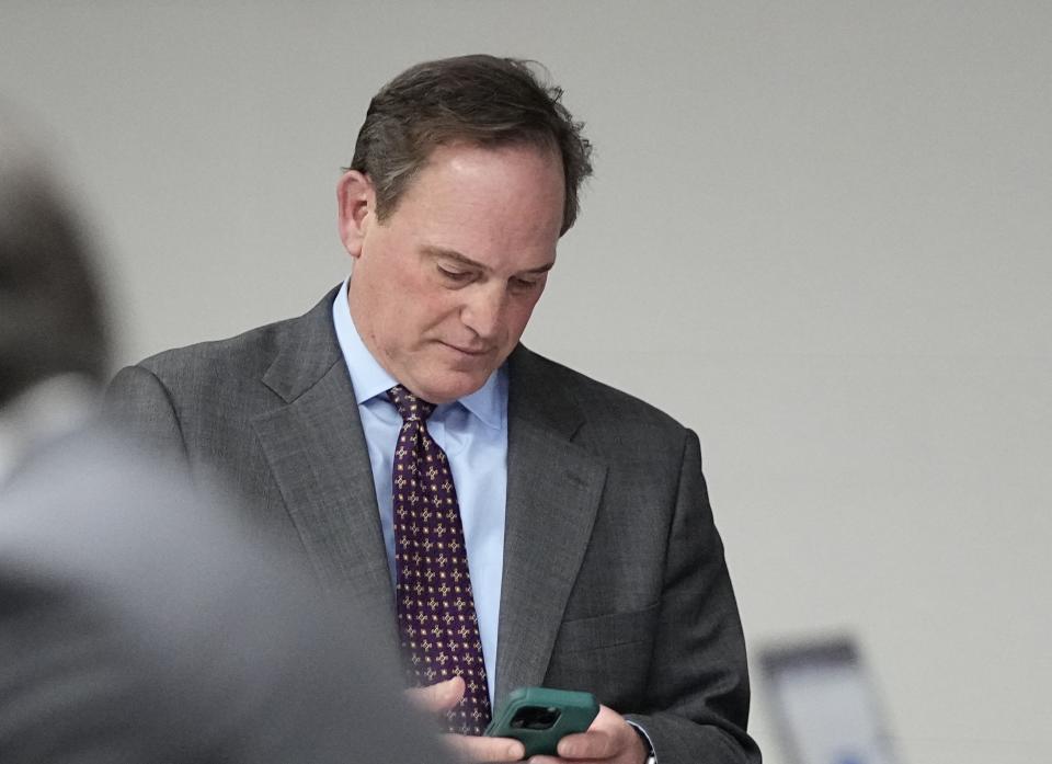 Geoffrey Blue, attorney for former President Donald Trump, looks at his phone after a hearing for a lawsuit to keep former President Donald Trump off the state ballot, Wednesday, Nov. 1, 2023, in Denver. (AP Photo/Jack Dempsey, Pool)