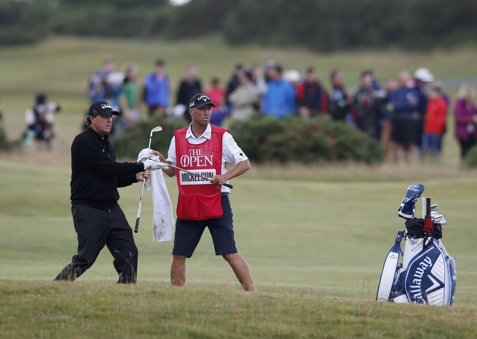 Phil Mickelson of the U.S. speaks to his caddie on the 16th hole during the final round of the British Open golf championship on the Old Course in St. Andrews, Scotland, July 20, 2015. REUTERS/Paul Childs