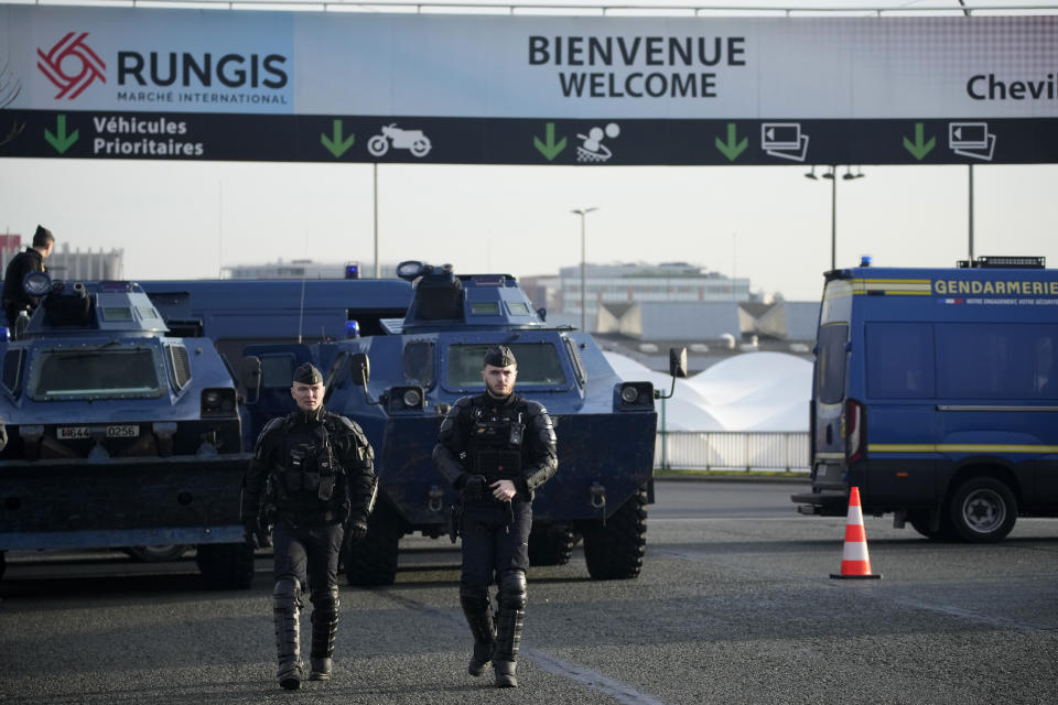 Gendarmes patrol at the entrance of the Rungis International Market, which supplies the capital and surrounding region with much of its fresh food, Monday, Jan. 29, 2024 south of Paris. Protesting farmers intended to encircle Paris with barricades of tractors, aiming to lay siege to France's seat of power in a battle with the government over the future of their industry shaken by the repercussions of the Ukraine war. (AP Photo/Christophe Ena)