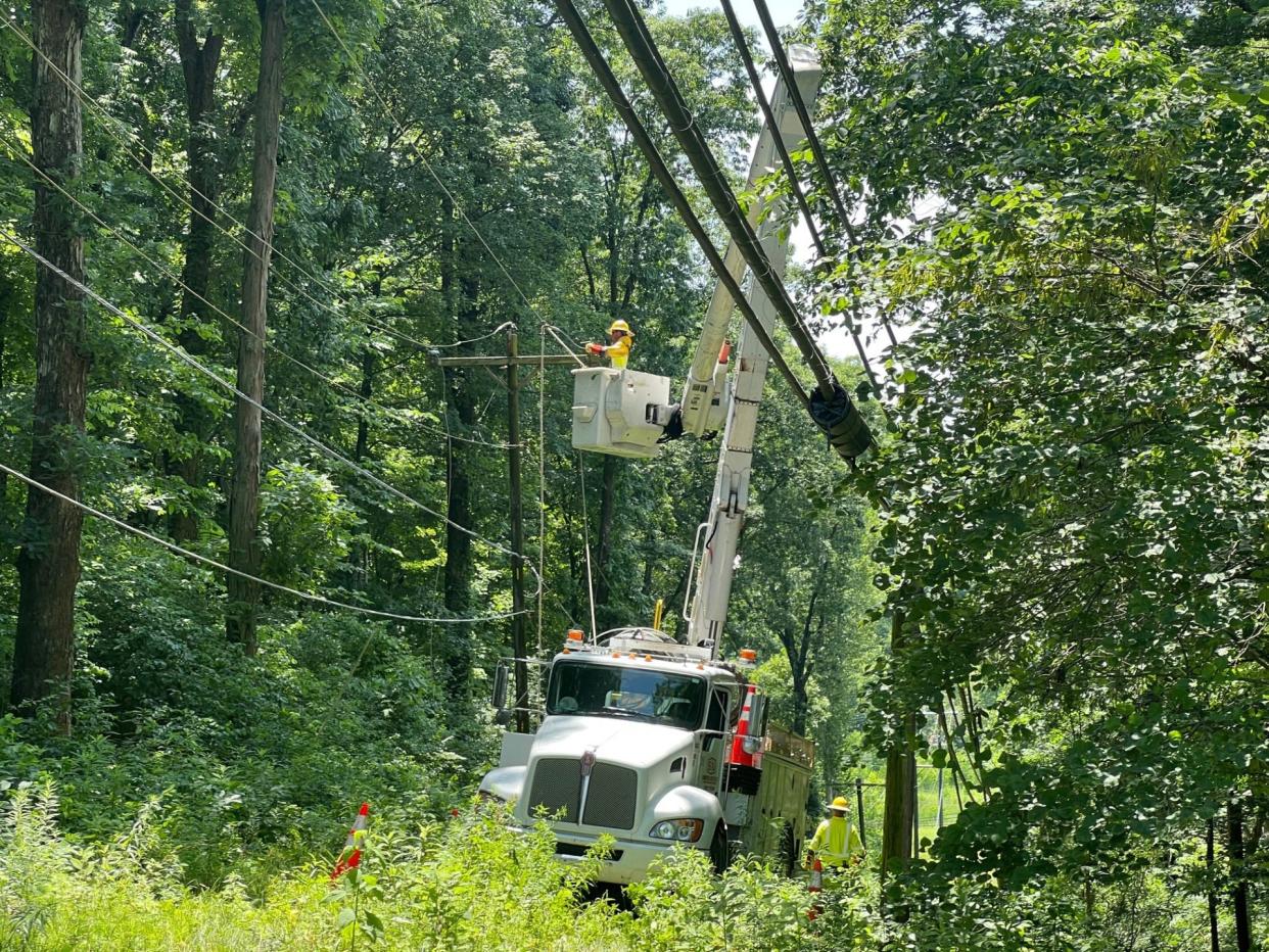 Duke Energy employees work to restore power around Monroe County after a June 29 derecho.