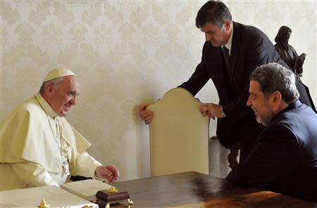 Pope Francis (L) talks to Saint Vincent and the Grenadines' Prime Minister Ralph Gonsalves (R) during a private audience at the Vatican December 19, 2013. REUTERS/Tiziana Fabi/Pool