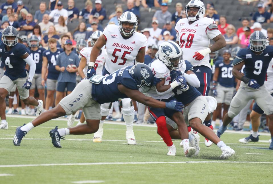 The Georgia Southern defense, including lineback Marques Watson-Trent, swarms South Alabama running back Braylon McReynolds on Saturday at Paulson Stadium in Statesboro.