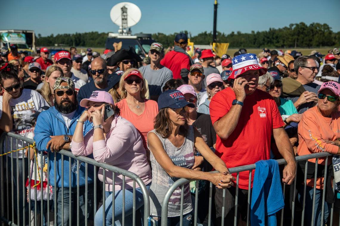 Supporters wait to gain entry to a GOP rally featuring former president Donald Trump, at Wilmington International Airport Friday, Sept. 23, 2022.