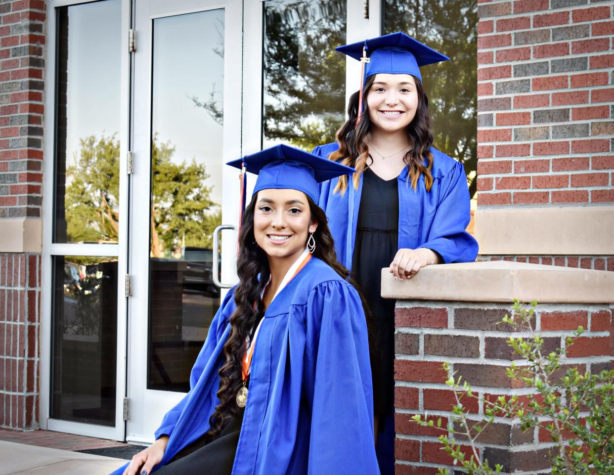 South Plains College graduates Bianca Saenz, seated, and Adamari Calderon.