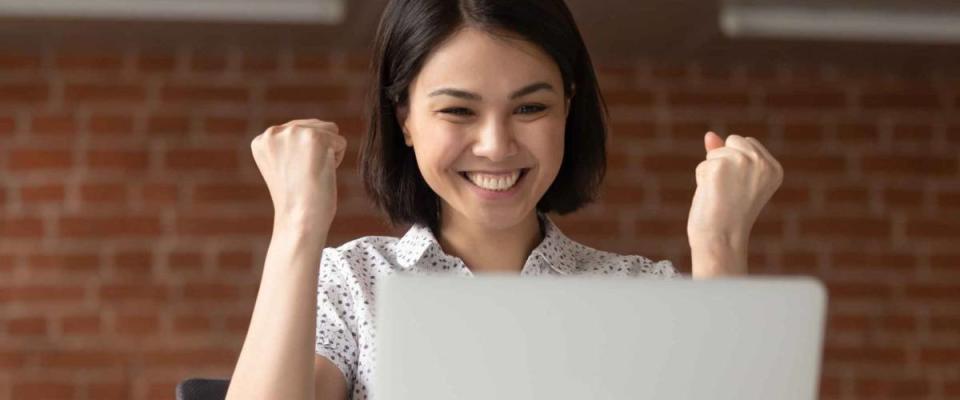 Overjoyed euphoric asian celebrating because she just landed a new job