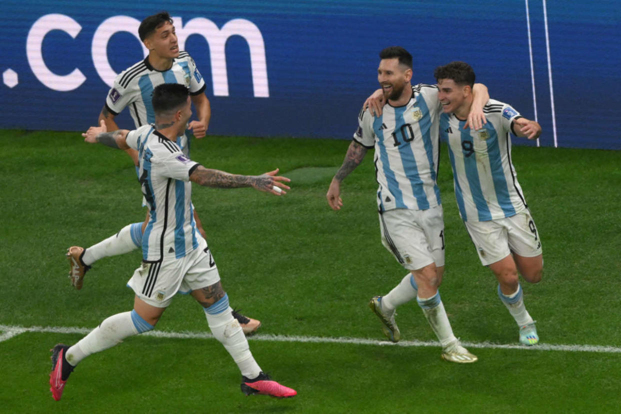 Argentina's forward #09 Julian Alvarez celebrates with Argentina's forward #10 Lionel Messi after scoring his team's second goal during the Qatar 2022 World Cup football semi-final match between Argentina and Croatia at Lusail Stadium in Lusail, north of Doha on December 13, 2022. (Photo by Paul ELLIS / AFP)