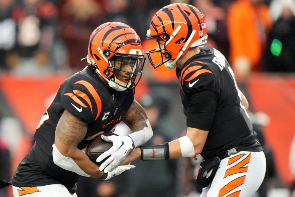 Cincinnati Bengals running back Joe Mixon (28) takes the carry from Cincinnati Bengals quarterback Jake Browning (6) in the fourth quarter during a Week 14 NFL game between the Indianapolis Colts and the Cincinnati Bengals, Sunday, Dec. 10, 2023, at Paycor Stadium in Cincinnati.