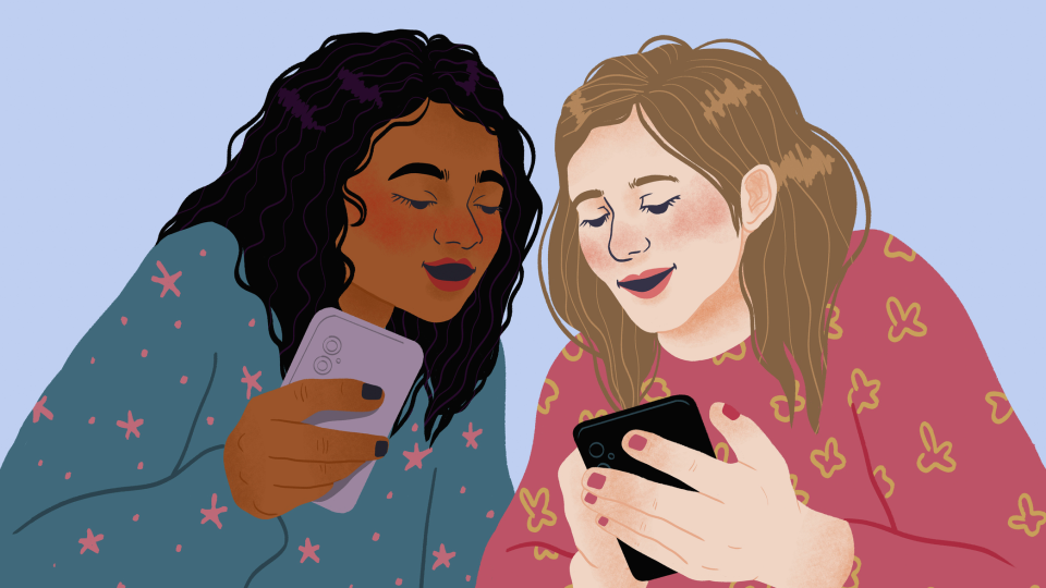 Two teenage girls using mobile phones together