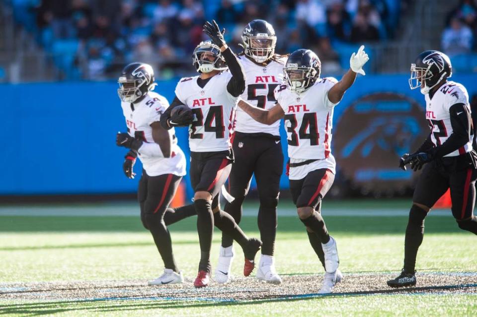 Falcons’ cornerback A.J. Terrell , second from left, celebrates with teammates after intercepting a pass by Panthers’ quarterback PJ Walker during the game at Bank of America Stadium on Sunday, December 12, 2021 in Charlotte, NC.