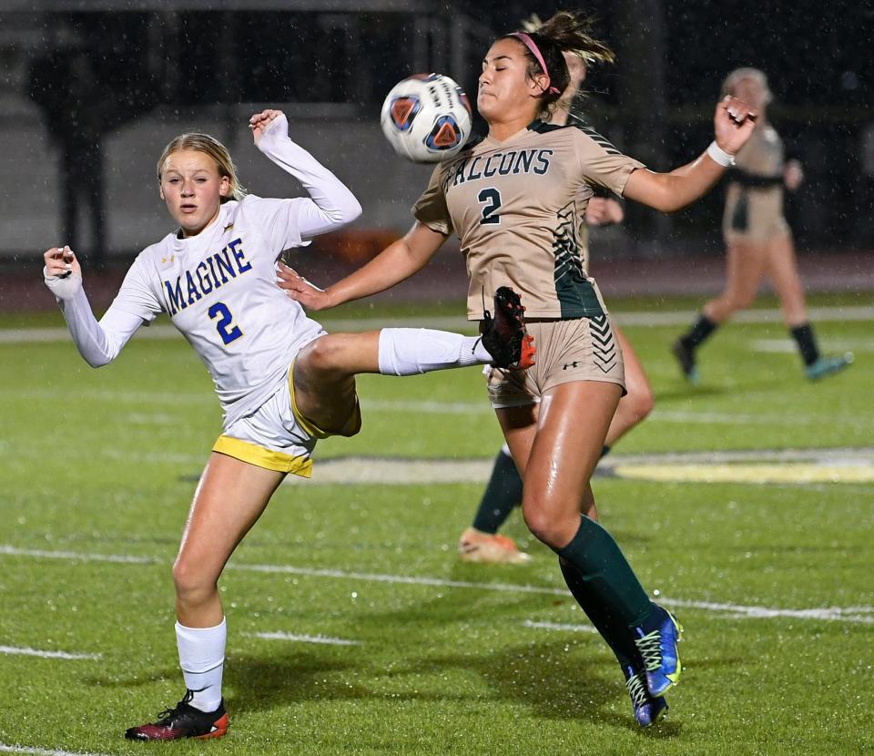 Imagine School's Addy Rattai, on left, and Saint Stephen's Episcopal's, Ava Foy, on right, chase after the ball during Tuesday night's Class 2A-Region 3 match in Bradenton.