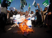 <p>Supporters of the Difa-e-Pakistan Council (DPC), an Islamic organization, chant slogans as they burn Israeli and U.S. flags during a protest against President Donald Trump’s decision to recognize Jerusalem as the capital of Israel, in Peshawar, Pakistan, Dec. 7, 2017. (Photo: Fayaz Aziz/Reuters) </p>